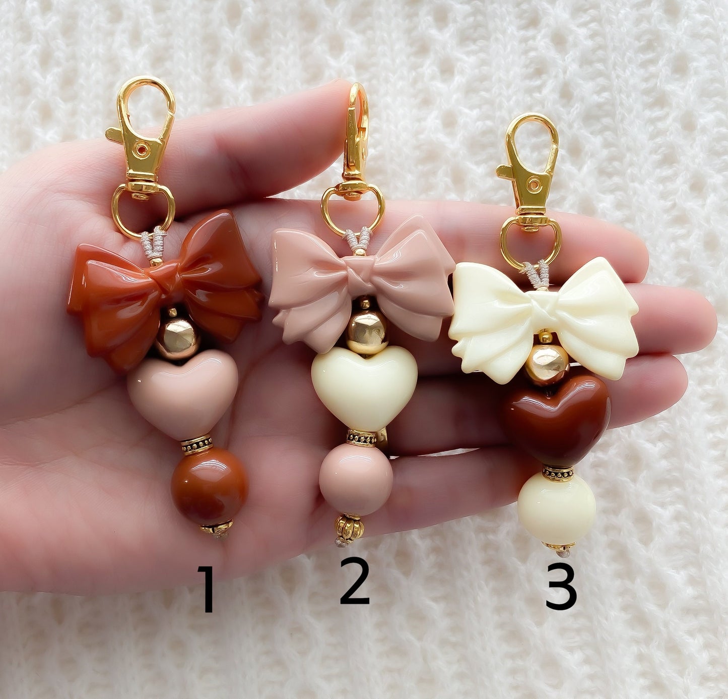 a hand holding three different types of earrings