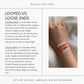 a woman wearing a red bracelet with the words looped vs loose ends