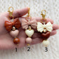 a hand holding three different types of earrings