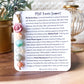 a card with a flower and beads on it