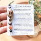 a person holding a card with a necklace on it